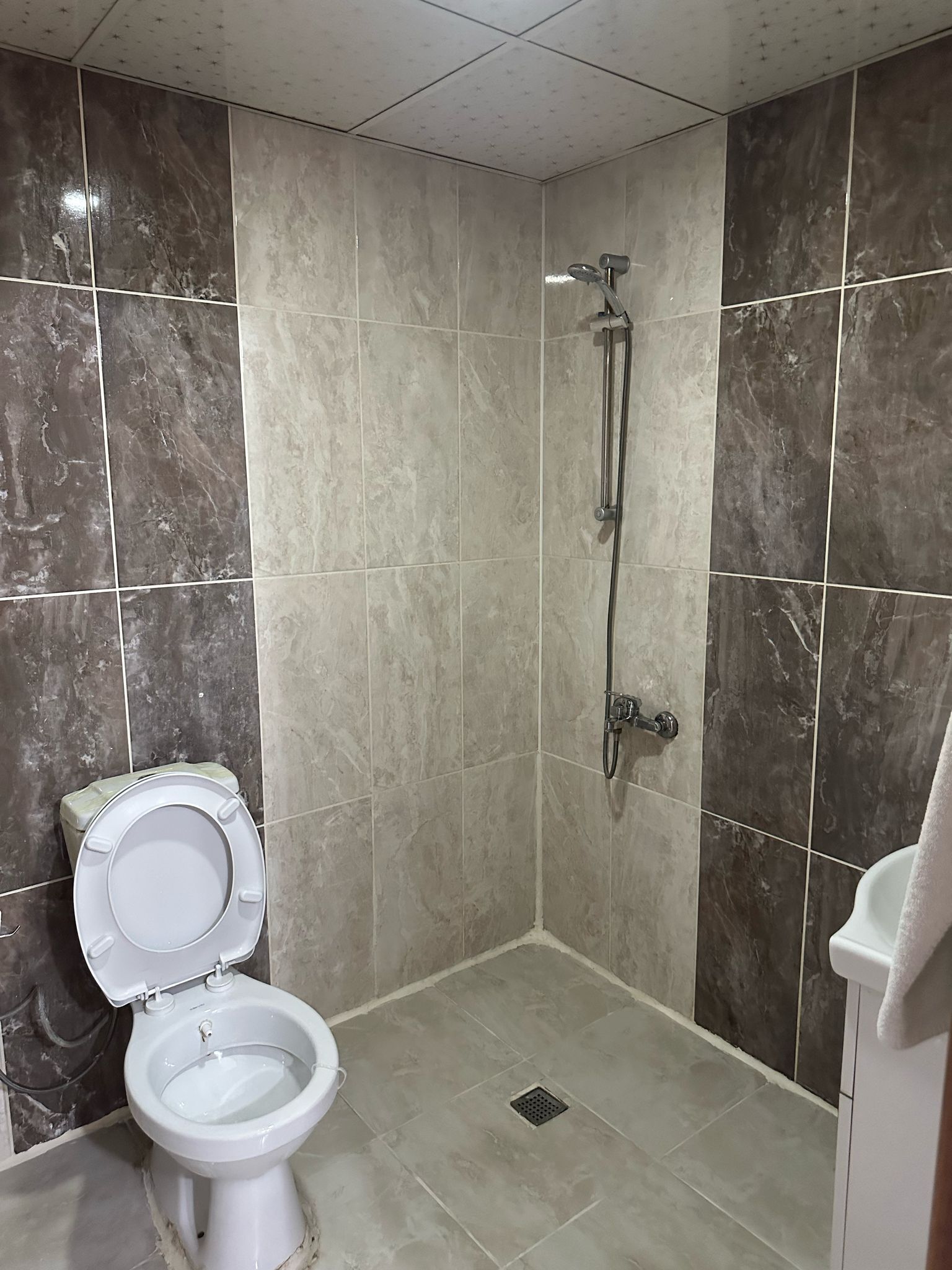 Shower, hair dryer, slippers, towels