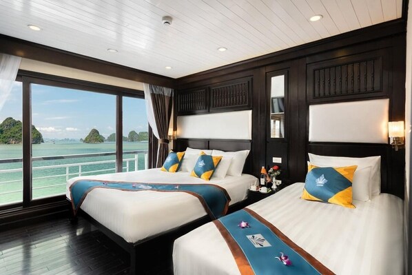 A hotel room with two beds, large windows with a view of the water, and a wooden ceiling. - Halong Deluxe 1 Cruise (Tuan Chau)