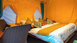 A tented room with a bed, two windows, and a chair. - Baspa Valley Adventure Camp (Rakchham)