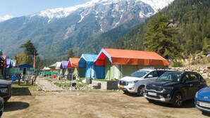 A row of colorful tents with a mountainous backdrop. - Baspa Valley Adventure Camp (Rakchham)