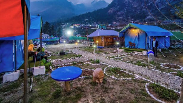 A campsite with tents, a small wooden cabin, and a clear view of mountains in the background. - Baspa Valley Adventure Camp (Rakchham)