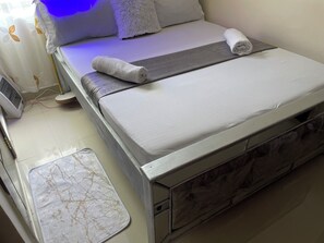 A neatly made bed with a grey blanket, a white pillow, and a rolled white towel. - Paradise Villa just outside Paradise/Karura forest for Nature visit,walks & more (Kiambu)