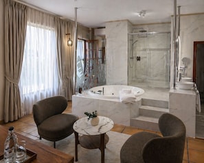 A modern bathroom with a glass-enclosed shower, a freestanding bathtub, and a vanity with a sink. - Hotel Jardin Secreto (La Orotava)