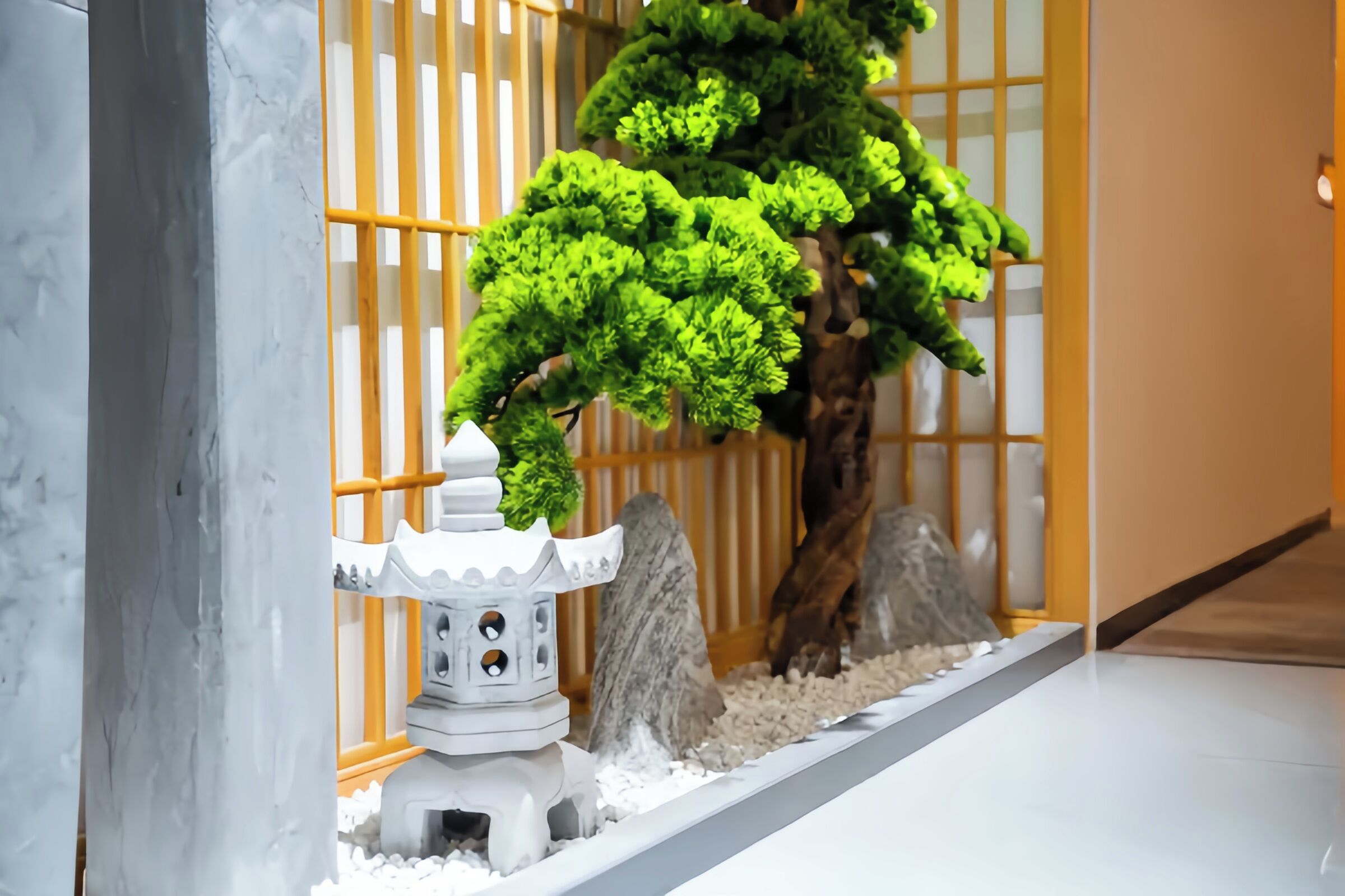 A traditional Japanese-style room with a shoji screen, a bonsai tree, and a small lantern.