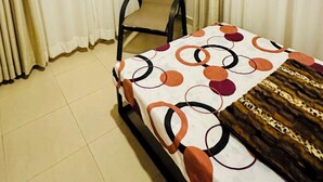 A hotel room with a bed, a chair, and curtains. - Small White House Njiro (Arusha)