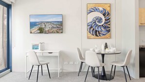 A modern room with a desk, chairs, a round table, and two artworks on the wall. - MetaWiseBnB Cronulla Beach Walk to Train & Shops 4 (Cronulla)