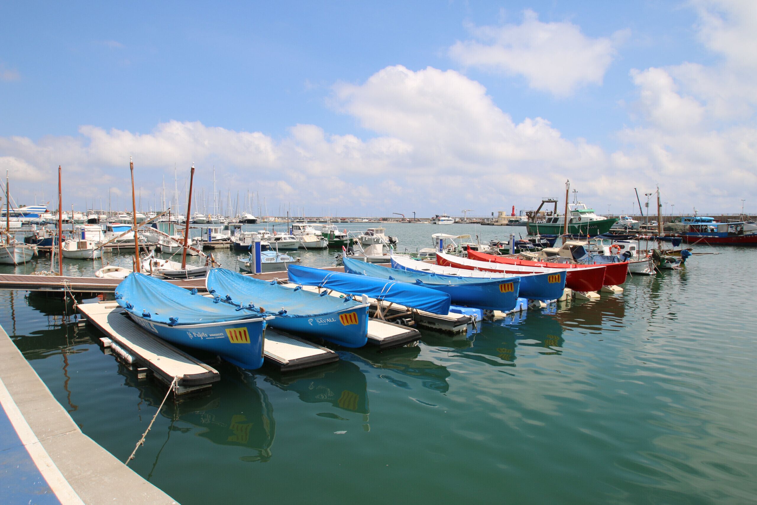 A marina with several boats docked at the pier.