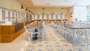 A spacious dining area with long tables and chairs, a central serving counter, and pendant lighting. - FRUIT VILLAGE PAESTUM Coral Beach (Capaccio-Paestum)