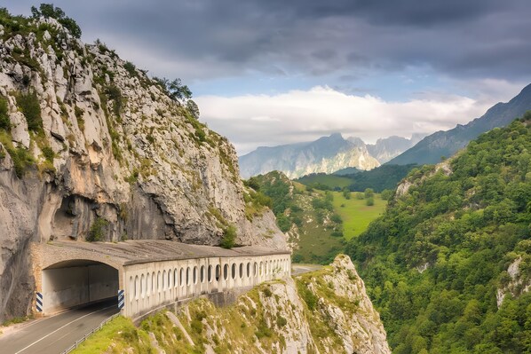 A mountain road with a tunnel and a bridge.