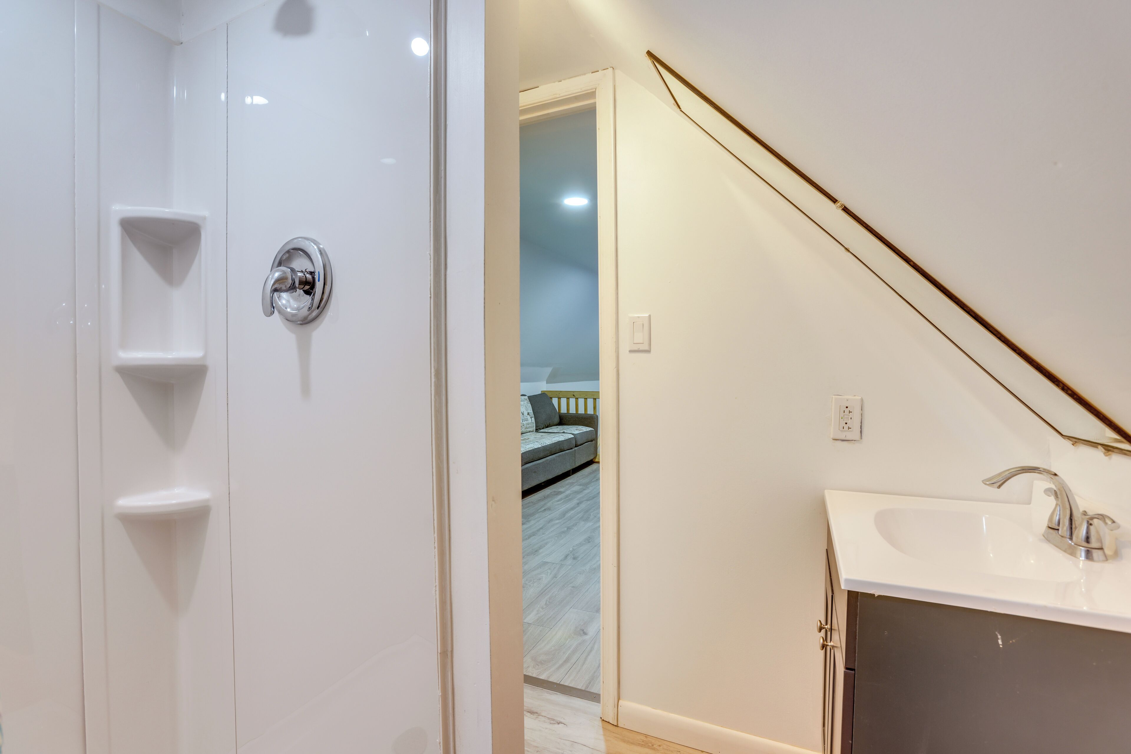 A bathroom with a shower, a sink, and a toilet.