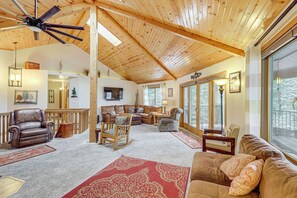 A spacious living area with a high ceiling, wooden beams, and large windows. - Deck + Game Room: Secluded Cabin Near Lake Cascade (Cascade)