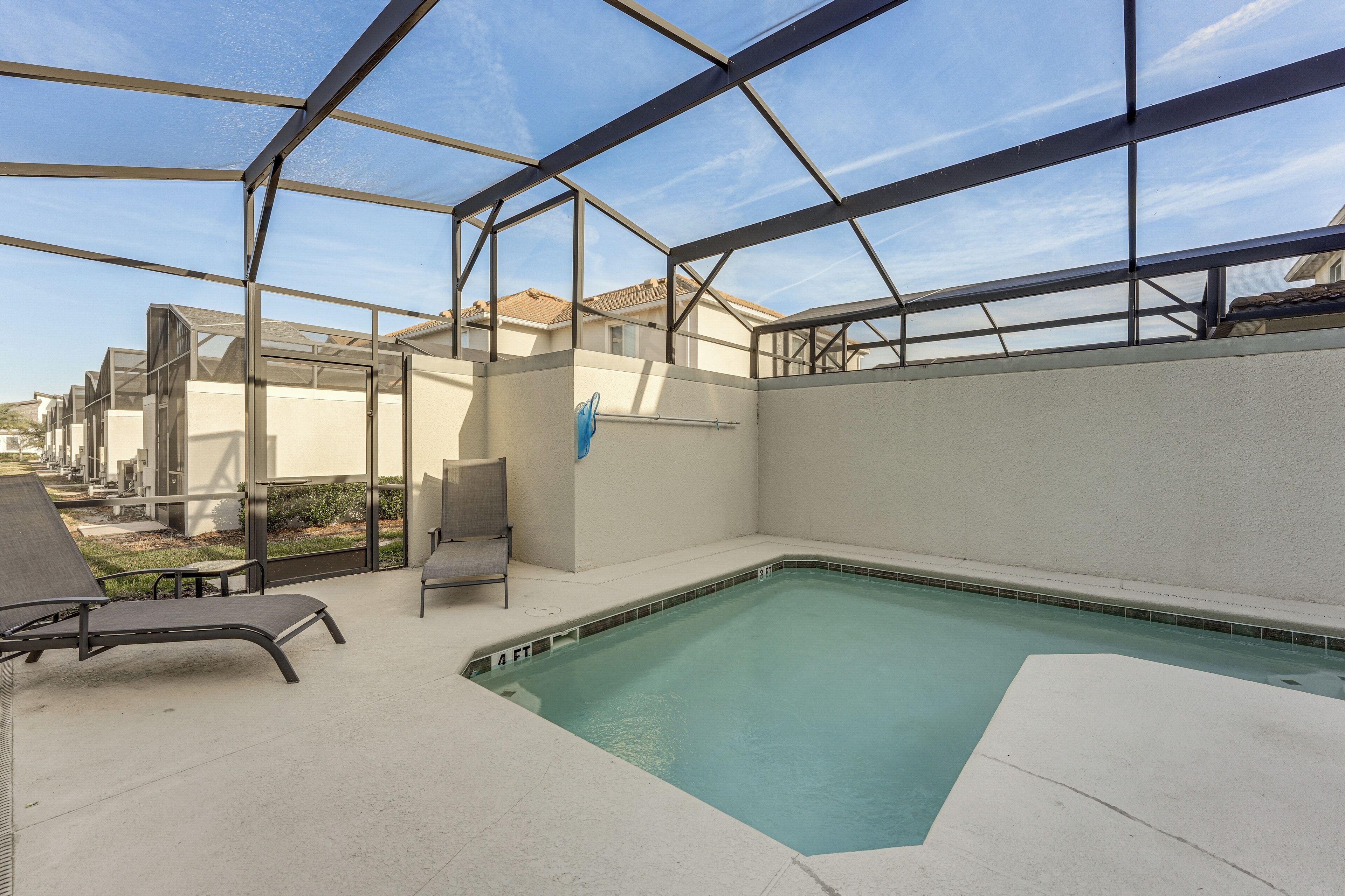 A covered outdoor swimming pool with a clear view of the surrounding buildings.