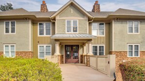 A two-story house with a front porch, stone foundation, and a chimney. - Condo on Lake Oconee: Big Water Views (Greensboro)