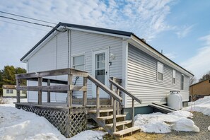 A single-story house with a wooden staircase leading to a front door. - Walk to Restaurants & Markets: Machias Home! (Machias)
