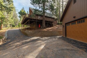 A two-story house with a covered porch, a garage, and a driveway leading to the house. - Mustang Sally- Free Lake Access! (Arnold)