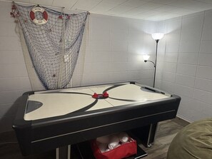 A pool table with a net and a welcome sign, a lamp, and a red storage box. - Little Lake Cove 2 Bedroom Home (Sevierville)