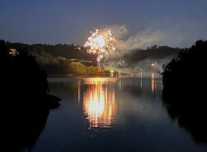 A nighttime scene with fireworks over a body of water, reflecting the lights. - Little Lake Cove 2 Bedroom Home (Sevierville)