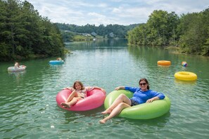 Two people floating on a lake in inflatable tubes. - Little Lake Cove 2 Bedroom Home (Sevierville)