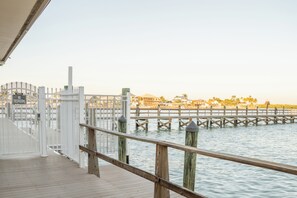 A wooden pier with a white fence and a sign indicating a pedestrian crossing. - Waterfront 2 bedroom 2 Bath condo with Amazing views and fishing in Marco Island (Marco Island)