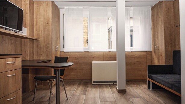 A compact living space with a kitchenette, a dining area, and a seating area. - Soothing 1-bedroom studio in charming Stuttgart perfect for your stay W3_P13 (Stuttgart)