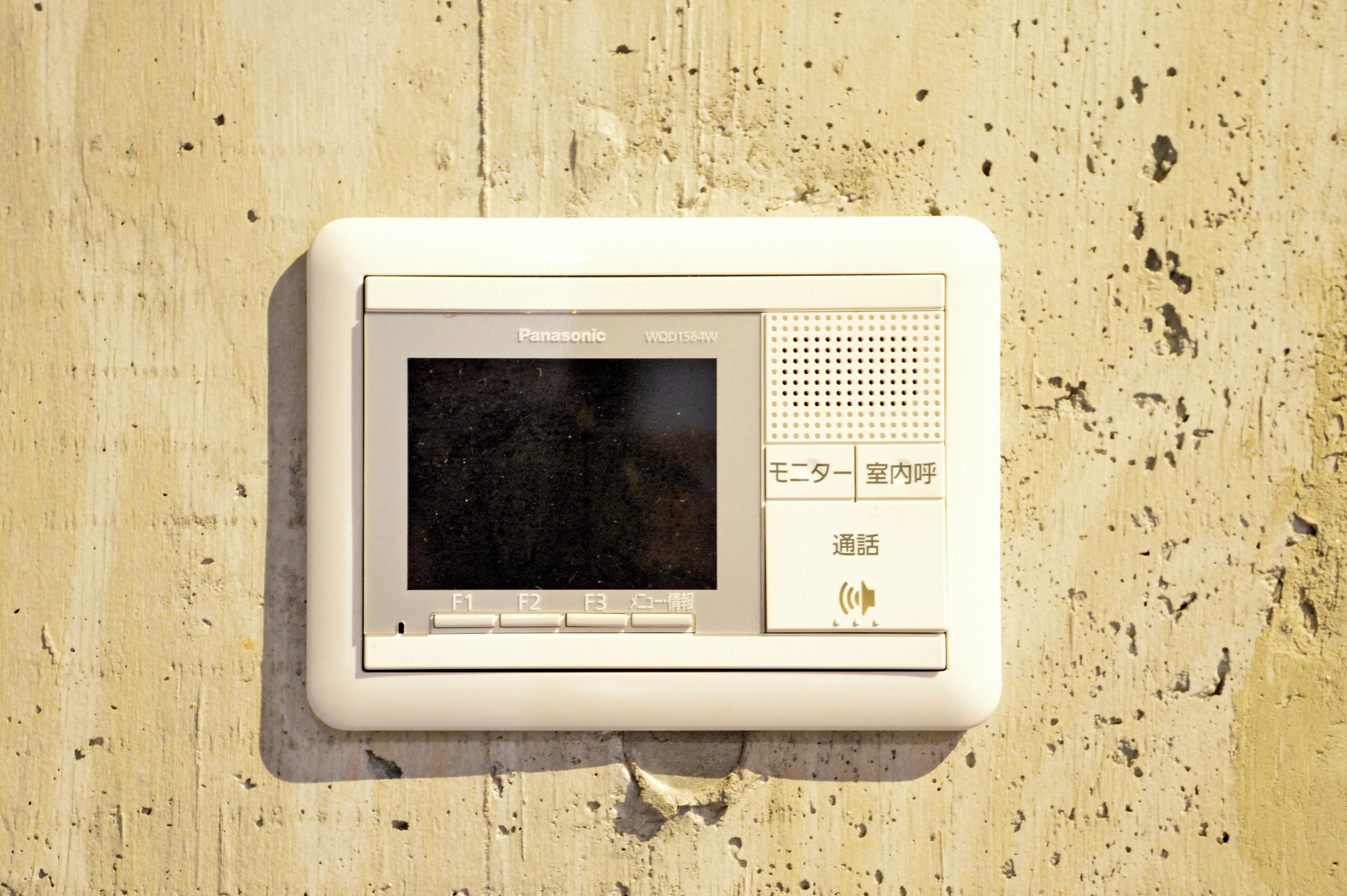 A Panasonic electronic device mounted on a wall.
