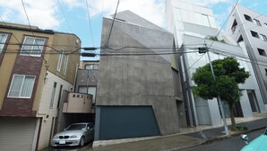 A modern building with a garage door, a parked car, and a tree in front. - 【Free pickup for over 4 nights stay】Center of the Tokyo Luxury 4-storey Villa (Minato City)