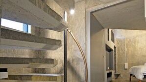 A modern interior with a concrete staircase, a metal curved structure, and a visible bathroom with a bed. - 【Free pickup for over 4 nights stay】Center of the Tokyo Luxury 4-storey Villa (Minato City)