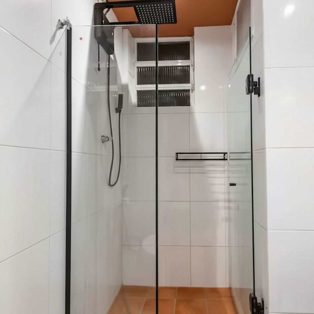 A glass-enclosed shower with a control panel, white tiled walls, and a visible vent.