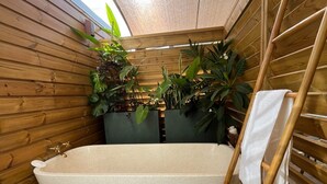 A wooden interior with a freestanding bathtub, wooden slats, and potted plants. - House with private pool - 4 guests (Saint-Joseph)