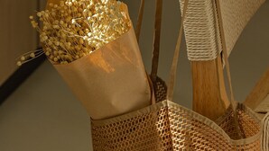 A woven bag with a handle and a paper bag containing dried flowers. - Luxury Suite with Private Pool by Kiva (Mitikas)
