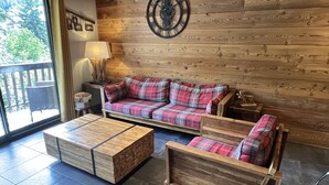 A wooden interior with a sofa and a coffee table. - Spacious apartment with balcony - 7 guests (Valloire)