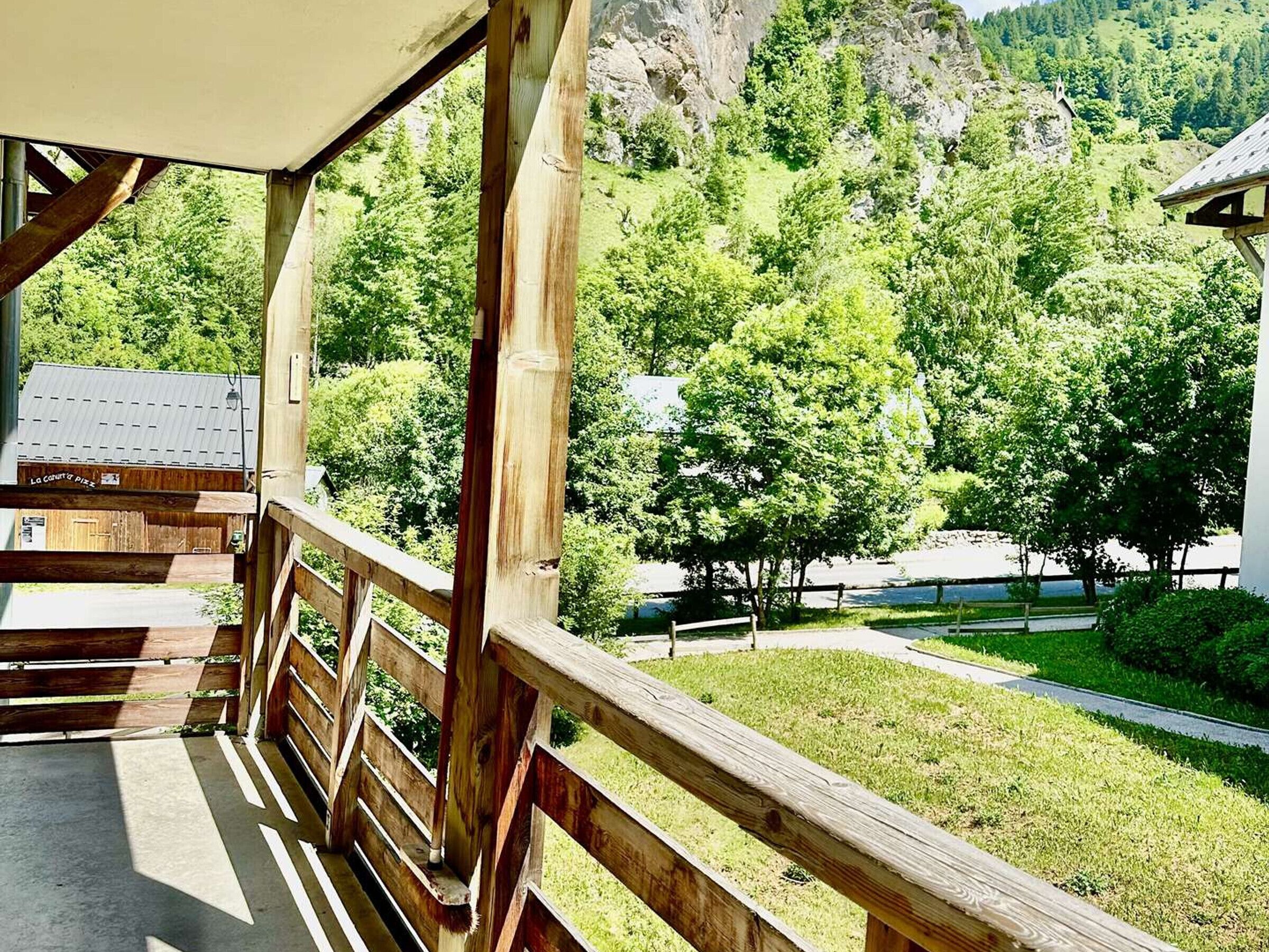 Une terrasse en bois offrant une vue sur un paysage montagneux.