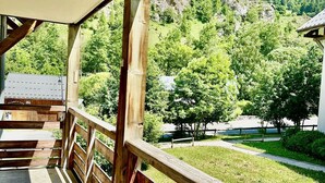 Une terrasse en bois offrant une vue sur un paysage montagneux.