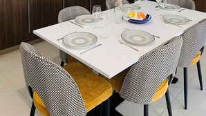 A modern kitchen with a dining area.