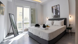 A modern bedroom with a large bed, a balcony, and a view of the outside. - Daedalus Minimal 1bedroom Bliss (Athina)