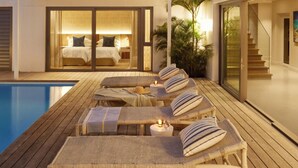 A modern two-story house with a pool, lounge chairs, and a staircase. - Walkers Beach (Plettenberg Bay)