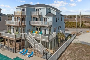 A multi-story building with a balcony and a pool area. - Serene Oasis – A New Wave of Beachside Bliss! (North Topsail Beach)