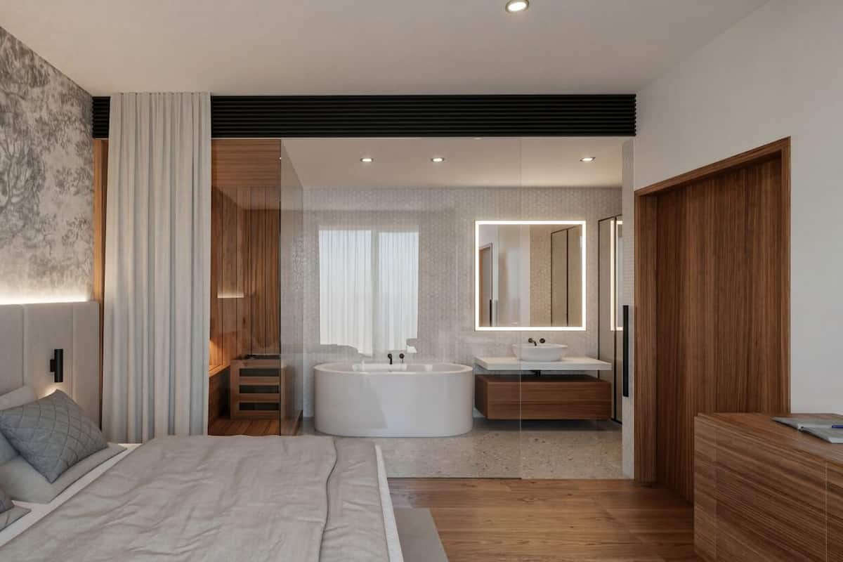 A modern bedroom with a large bed, a bathroom with a bathtub and a sink, and a wooden wardrobe.