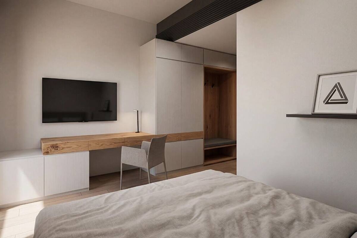 A modern bedroom with a bed, a desk, and a chair.