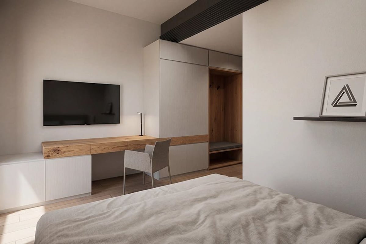 Un dormitorio moderno con una cama, un escritorio y una silla.