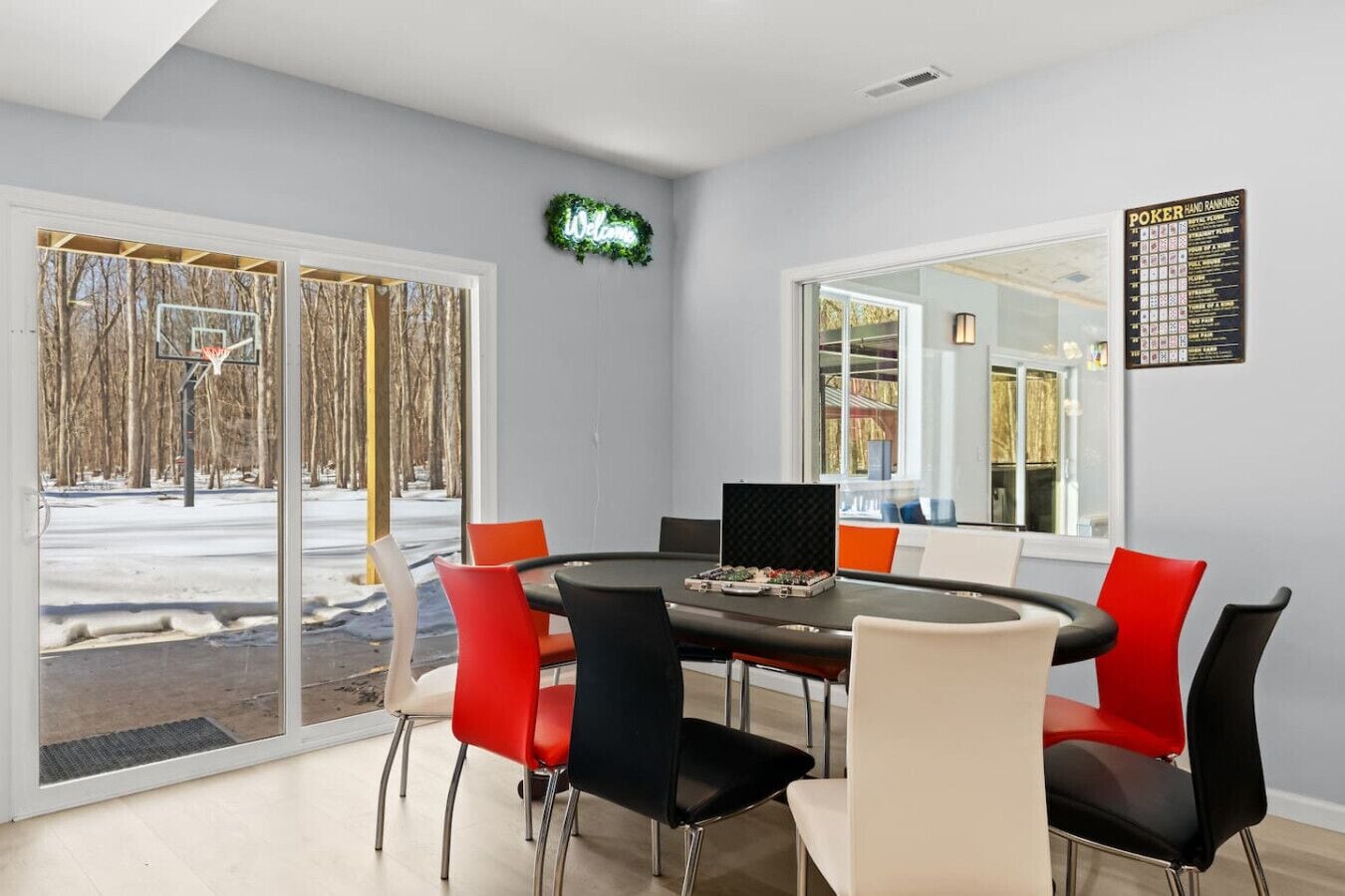A conference room with a round table, chairs, and a large window.