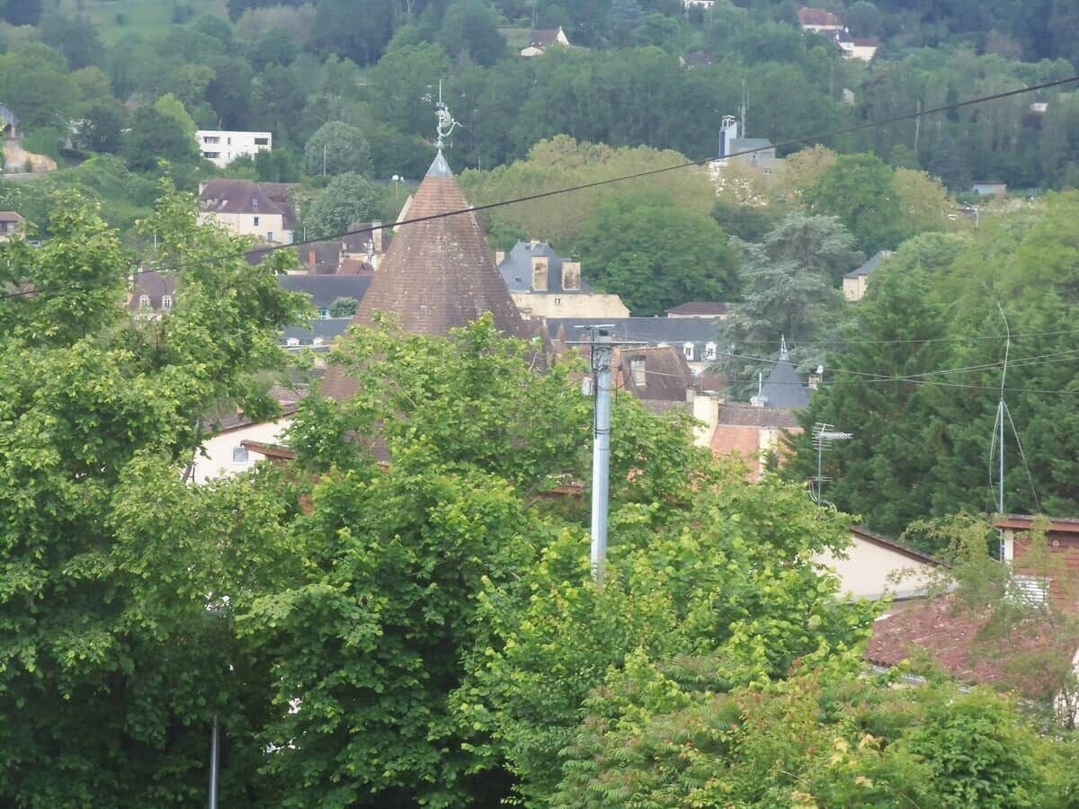 Een stad met een opvallende kerktoren en omliggende woonhuizen.