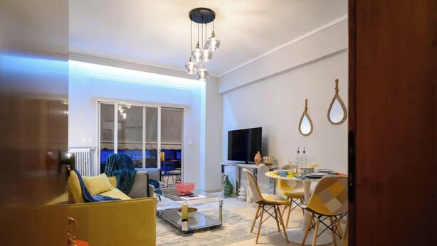 A modern living room with a sofa, coffee table, and dining area. - Serenity and 2 bedroom Luxury in Kalamaria (Kalamaria)