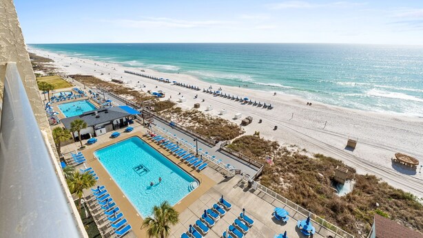 A resort with a large pool, beach access, and a view of the ocean. - Gulffront Condo w/ Tiki Bar, Pools, & Sunsets (Panama City Beach)