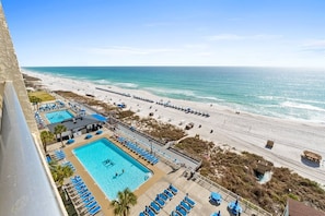 A beachfront hotel with a swimming pool, beach access, and a view of the ocean. - Gulffront Condo w/ Tiki Bar, Pools, & Sunsets (Panama City Beach)