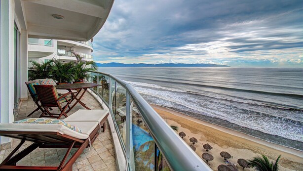 A balcony with a view of the beach and ocean. - Beachfront Condo + Pool - 2 Bedrooms, 2 king beds, 2 baths, w/ AC - Kite Towers (Nuevo Vallarta)