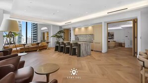 A spacious living area with a dining set, sofas, and a large window. - City Views with Bright 1BR Refined in 501 Miami (Miami)