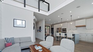 A modern apartment with a living room, dining area, and kitchen. - Beautiful home located in OBP. Located on a beach block. Great home when visiting the island, all the amenities included. (OCEAN BEACH)