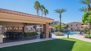 An outdoor patio area with a pool, palm trees, and a covered seating area. - Upscale Stay w Heated Pool 8mins to ASU (Tempe)