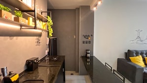 A modern kitchen with a built-in stove, a coffee machine, and a countertop. - Rio Select - Copacabana  (Rio de Janeiro)
